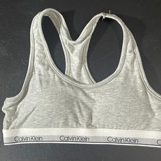 Calvin Klein Sports Bra Size Medium Girls 7/8 Gray New With Tag Smoke Free Pet Free Home Fitted Calvin Klein Athleisure Tops, Calvin Klein Sporty Activewear With Medium Support, Sporty Calvin Klein Tops For Sports, Calvin Klein Sporty Activewear For Gym, Calvin Klein Fitted Sports Bra, Calvin Klein Sporty Fitted Sports Bra, Calvin Klein Sporty Stretch Top, Calvin Klein Sporty Medium Support Sports Bra, Calvin Klein Athleisure Tops For Sports