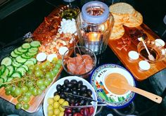 a table topped with plates and bowls filled with different types of food next to drinks