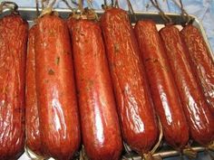 several sausages are lined up on a tray