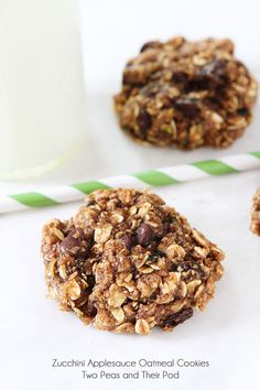 cookies with chocolate chips and oatmeal are next to a glass of milk