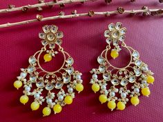 Yellow Polki Kundan Chandbali Earrings. Light Weight Earrings. Height 4 inch Width 2.5 inch Handcrafted pair of earrings. Gives a traditional look. Can be worn for engagement and wedding parties. Indulge in it or gift it and watch the compliments flow! It is advisable to store jewelry in a zip lock pouch (air tight pouch), keep away from water perfume and other chemicals and clean it with soft cloth. FREE SHIPPING!! Kundan Chandbali, Kundan Jhumka, Meenakari Earrings, Pakistani Earrings, Water Perfume, Chandbali Earrings, Earrings Indian, Store Jewelry, Traditional Earrings