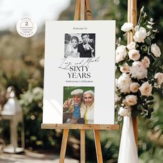 an easel with a sign that says sayy years and two photos on it