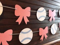 paper bows and baseballs are hanging on the wall