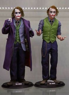 the joker and person statues are on display