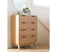 a wooden dresser sitting in front of a mirror on top of a hard wood floor