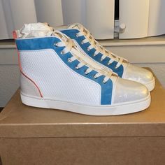 A Signature High-Top Sneaker With Color-Pop Accents, Wavy Abstract White Pattern And Translucent Toe Box, And A Logo-Debossed Red Inset At The Sole. Blue Leather High-top Sneakers With Perforations, Christian Louboutin Red Bottoms, Christian Louboutin Sneakers, Black High Top Sneakers, Studded Sneakers, Red Louboutin, Christian Louboutin Men, Luxury Sneakers, Black High Tops