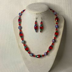 A Unique One Of A Kind Set Featuring Red Iridescent Marquis Shaped Glass, Round Glitter Rainbow Beads, And Crystals. Finished With A Pewter Clasp And Measures 18” Long. The Earrings Are In Sterling Silver And Measure 1.25” Long. Fun And Sparkly! Red Round Beads Jewelry For Christmas, Multicolor Round Beads Christmas Jewelry, Red Beaded Christmas Jewelry, Red Jewelry For Christmas Celebration, Red Faceted Beads Jewelry For Christmas, Multicolor Round Beads Jewelry For Holidays, Adjustable Red Necklace For Holiday, Red Christmas Jewelry With Colorful Beads, Multicolor Bohemian Jewelry For Holidays