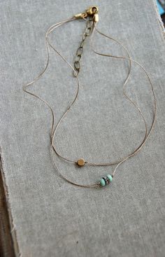 "So simple and chic! Features light green/ aqua glass beads,rhinestone bead,gold bead,khaki colored cord. Necklace measures 14\" with a 2 \" extension. Necklace finishes with a lobster claw closure." Adjustable Minimalist Layered Choker Necklace, Adjustable Dainty Choker For Layering, Adjustable Minimalist Multi-strand Layered Necklace, Adjustable Minimalist Beaded Chain Choker, Minimalist Adjustable Beaded Chain Choker, Adjustable Turquoise Dainty Choker, Dainty Turquoise Adjustable Choker, Minimalist Round Beads Choker For Festival, Minimalist Necklace With Adjustable Chain For Festival