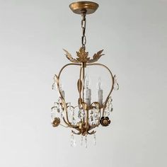 a chandelier hanging from the ceiling in a room with white walls and flooring