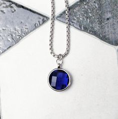 《《  FOR YOUR JOURNEY COLLECTION  》》 THE DETAILS The "FACETED SAPPHIRE COIN" Necklace is designed with an incredibly detailed Silver Stainless Steel Open Ring Bezel Pendant, with a luxurious lightweight Micro-Faceted Cushion Cut Sapphire Cubic Zirconia Stone, suspended from a Silver Stainless Steel Box Chain available in your choice of length! GEMSTONE BENEFITS SAPPHIRE CUBIC ZIRCONIA: Known as the Stone of "WISDOM & PROSPERITY", often worn for its abilities to stimulate concentration, while enha Multicolor Pearl Necklace, Blue Sapphire Pendant, Ring Bezel, Coin Pendant Necklace, Mens Chain Necklace, Garnet Pendant, Bezel Pendant, Sapphire Pendant, Boyfriend Anniversary Gifts