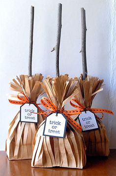 three bags with tags tied to them sitting on a table next to some sticks and twig