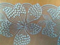 an embroidered lace with flowers on it