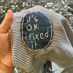 someone is holding up a piece of fabric that says it's okay to fix it