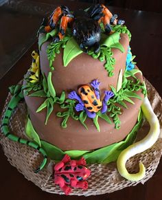 there is a cake decorated with animals and plants