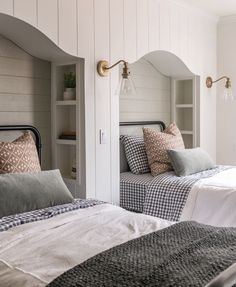 two beds in a room with white walls