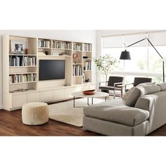 a living room filled with furniture and a flat screen tv mounted on a wall next to a window