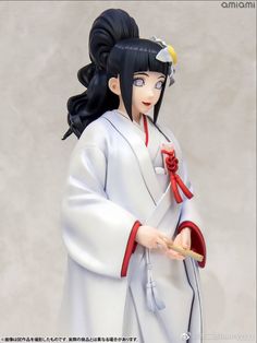 a figurine of a woman dressed in traditional japanese clothing