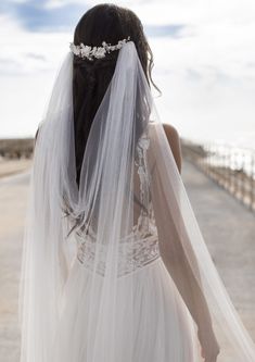 the back of a bride's dress, with her veil draped over her head