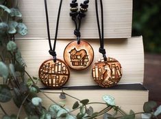 three wooden pendants on top of a book