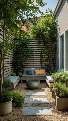 an outdoor seating area with trees and plants on the side of the building, surrounded by gravel