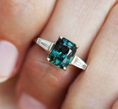 Dolores Radiant Teal Sapphire Ring with Baguette Diamonds – Capucinne Engagement Ring Baguette, Baguette Engagement Ring, Teal Sapphire, Baguette Diamond Rings, Alexandrite Engagement Ring, Alexandrite Ring, Ceylon Sapphire, Sapphire Engagement Ring, Three Stone Engagement