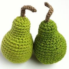 two crocheted pears sitting next to each other