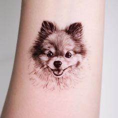 a small dog's face is drawn on the arm