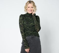 Just what your wardrobe needs -- a versatile long-sleeve top you can wear solo or layered under a jacked or blazer. The cozy funnel neckline keeps you warm, while thumbholes at the cuffs are an edgy detail that brings a touch of fashionable functionality to this chic everyday style. From Studio ParkTM x Shawn Killinger. Trendy Long Sleeve Turtleneck For Fall, Winter Stretch Long Sleeve Top With Thumbholes, Stretch Fall Turtleneck, Fall Mock Neck Top For Layering, Stretch Turtleneck For Fall, Versatile Long Sleeve Mock Neck Top For Layering, Winter Stretch Tops With Thumbholes, Versatile Long Sleeve Turtleneck For Winter, Versatile Turtleneck Long Sleeve Top For Fall