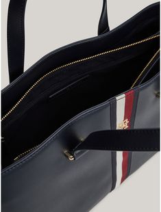 Tommy Hilfiger women's bag. Signature branding and gold-tone hardware set the tone of this sophisticated tote bag, complete with dual carry handles for comfortable toting. It also features side zips and an expandable lining to change its shape and add room to the main compartment.  Material: 100% Polyurethane. Daily Use Double Handle Bag With Branded Hardware, Tommy Hilfiger Bags With Zipper Closure For Everyday Use, Tommy Hilfiger Rectangular Leather Bag, Tommy Hilfiger Bags With Zipper For Everyday, Tommy Hilfiger Leather Shoulder Bag For Daily Use, Everyday Tommy Hilfiger Bag With Zipper Closure, Elegant Tommy Hilfiger Leather Shoulder Bag, Elegant Tommy Hilfiger Leather Bag, Classic Tommy Hilfiger Everyday Bag