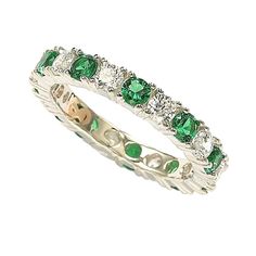 a white gold ring with emeralds and diamonds