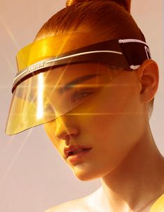 a woman with sun glasses on her head and the sun shining through her lens to make it look like she's wearing an eye mask