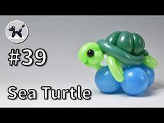 an inflatable sea turtle sitting on top of a blue ballon with the words 39