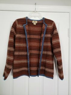 Vintage Woolrich Sweater Cardigan 100% Wool Button Ribbon Raisin Brown Large. Great condition! Lovely striped design with blue trim. Colors are like a rust/orange brown, dark brown and tan. *Pilling throughout, kind of itchy like most pure wool.* Approx. measurements (when buttoned)- Pit to pit: 19" Length from shoulder to bottom hem: 24" Sleeve length: 24" Will ship out within 1 business day of payment. Thanks! Vintage Long Sleeve Cardigan For Layering, Vintage Style Long Sleeve Cardigan For Layering, Vintage Brown Cardigan With Button Closure, Vintage Brown Outerwear For Layering, Vintage Brown Sweater For Layering, Vintage Brown Long Sleeve Cardigan, Brown Vintage Long Sleeve Cardigan, Funky Cardigans, Retro Sweaters