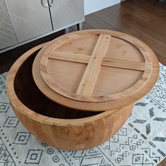 a wooden box sitting on top of a rug