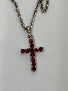 This is a silver tone costume jewelry red rhinestone cross pendant necklace. Comes with a silver tone 19 inch chain. No identifiable markings on chain or cross pendant that I can find. Materials unknown. Happy shopping! Red Cross Pendant Necklace For Gift, Red Cross Pendant Necklace Gift, Red Sterling Silver Cross Necklace, Red Cross Necklace, Handmade Red Cross Pendant Jewelry, Elegant Red Cross Pendant Jewelry, Metal Rhinestone Cross Pendant Necklace, Angel Pin, In Remembrance Of Me