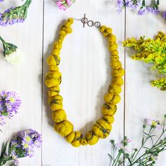 This felted necklace celebrates the beauty of Tiger's Eye on a grand scale! Wool and black sari silk re-create Tiger's Eye textures in fiber. Unique and light weight, perfect for layering for a bohemian look. Artisan Yellow Necklaces For Festivals, Handmade Yellow Necklaces For Festivals, Yellow Necklace For Festival Gifts, Yellow Necklace For Festivals And Gifts, Yellow Bohemian Necklaces For Festive Occasions, Sari Silk Necklace, Black Sari, Tropical Necklace, Wool Necklace