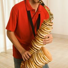 a man holding a large stack of bread