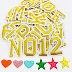 the letters and numbers are made out of sequins, with three stars around them