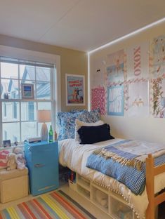 a bed room with a neatly made bed and colorful rugs on the floor next to a window