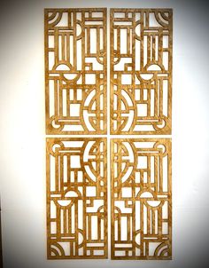 four wooden panels with designs on them in a wall mounted art piece that is made out of wood