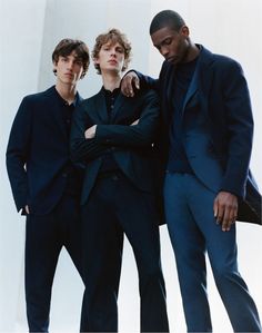 three young men standing next to each other