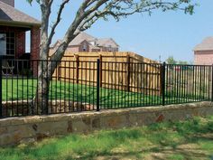 a fenced in yard with grass and trees