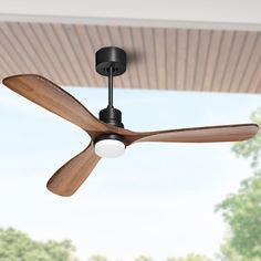 a ceiling fan with two wooden blades and a white light bulb hanging from it's side