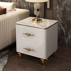 a white and gold nightstand with a lamp on top