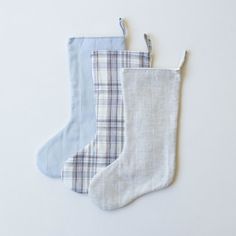 two pairs of socks hanging on a white wall