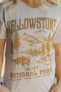 Celebrate your love for the great outdoors with the Yellowstone National Park Graphic T-Shirt! Crafted from 100% cotton, this tee offers a soft, breathable feel for all-day comfort. Featuring bold Yellowstone text and a National Park graphic, this t-shirt is perfect for nature enthusiasts. Its classic fit makes it easy to pair with jeans, shorts, or layer under a cozy flannel! National Park Graphic, Revival Clothing, Fall Style Guide, Gameday Dress, Loungewear Dresses, Casual White Dress, Concert Looks, Cozy Flannel, Game Dresses