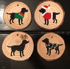 four wooden ornaments with dogs painted on them