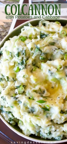 a bowl filled with mashed potatoes and broccoli on top of a table