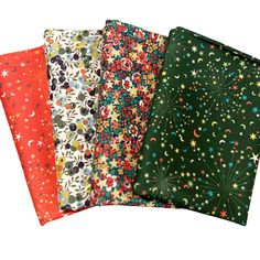 four different colored fabrics with stars and moon designs on them, all in various colors