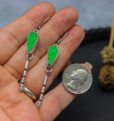 These earrings feature gorgeous green uvarovite druzy drops and hand carved spikes that dangle below the stones. Super long and lean, lightweight and fun to wear. I have given the earwire a slight twist so that they hang facing forward enough that you can see the stones and not to the sides so you can't enjoy them. That means there is a left and right earring when you go to wear these. ♦︎Length: The earrings are 2 3/4 inches long from the top of the hook to the bottom of the dangle. ♦︎Ear Wire: Unique Green Long Drop Earrings, Unique Green Long Drop Jewelry, Spike Earrings, Dainty Earrings, Earrings Sterling Silver, Ear Wire, Stone Earrings, Sterling Earrings, Druzy